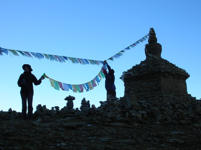 Ray and Linda putting up prayers flags on the inner kora. Mt. Kailash, Tibet.
